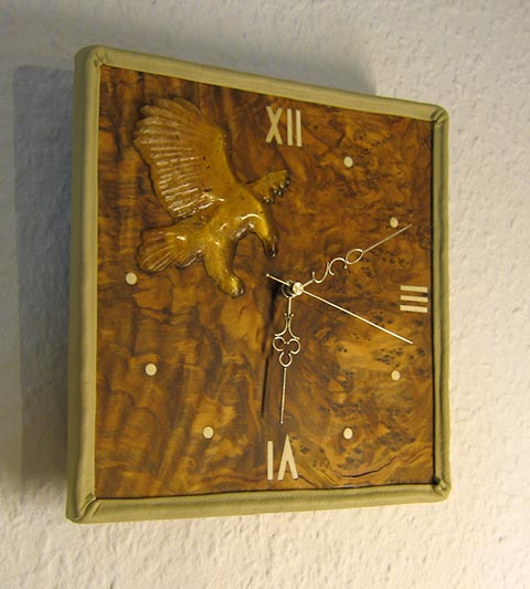 Wall clock 'Eagle Catches Time' (olive wood, amber, silver, mammoth ivory). Original work by Alexander Babel. 2008.
