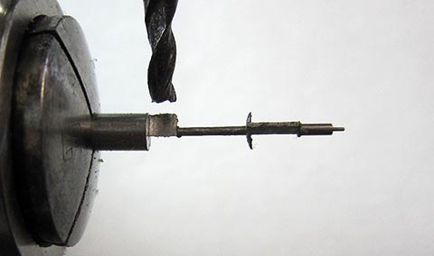 Milling the short pallet of the balance staff. Antique table clock with verge escapement and fusee-and-chain drive.