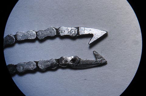 Manufacturing the fusee chain. Two hooks shown; the upper one is self-crafted. Antique verge escapement table clock with fusee drive.