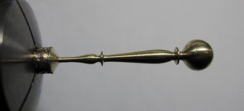 Antique verge escapement table clock. Manufacturing the minute hand. The hand turned to shape on a lathe.