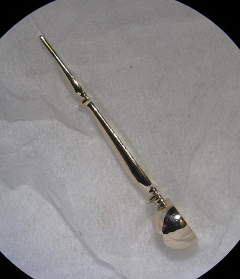 Antique fusee bracket clock. Manufacturing the minute hand. Flat side with square hole for the cannon pinion. Side view.