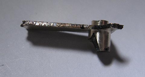 Antique fusee bracket clock. Manufacturing the hour hand. Cylinders machined on both sides at one end of the blank. Side view.