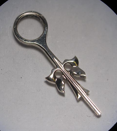 Manufacturing the hour hand. Final polished and finished gold hour hand. Antique fusee bracket clock.