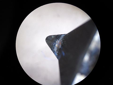 Industrial diamond, sharpening a diamond cutter under the microscope.
