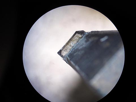 Industrial diamond, sharpening a diamond cutter under the microscope.