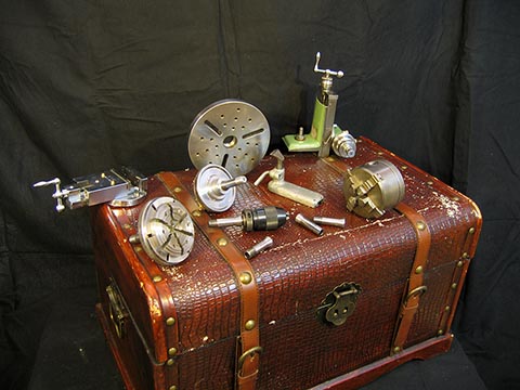 Accessories for Schaublin 70: four- and six-jaw chucks, various sizes of W12 collets, vise, jaw chuck, hand rest, and faceplate.